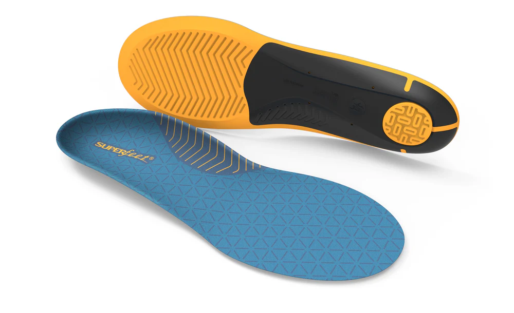 Top view of a blue patterned shoe insole with a geometric texture; an orange and black outsole is visible beneath.