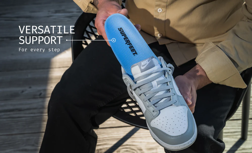 View2_All-Purpose_Support_Medium-Arch_2731x1667_ed4f0134-91cf-4fb3-8e8a-c9416cf504ae - Horizon Industries Close-up of a gray Nike sneaker being held, featuring a bright blue insole labeled SUPERFLEET to emphasize versatile support for every step.