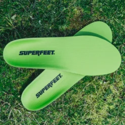 View8_All-Purpose_Support_High-Arch_2731x1667_b22be67b-f5f6-4ae5-a931-9a40c3abbf29 - Horizon Industries Bright green Superfeet insoles lying on grass, branding visible on each insole