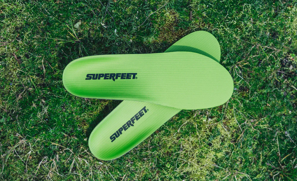View8_All-Purpose_Support_High-Arch_2731x1667_b22be67b-f5f6-4ae5-a931-9a40c3abbf29 - Horizon Industries Bright green Superfeet insoles lying on grass, branding visible on each insole