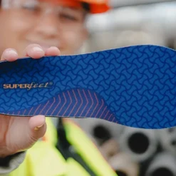 View8_Work_Cushion_2731x1667_366b8149-ea15-49a8-96ce-1e0244b8c658 - Horizon Industries Blue Superfeet orthotic insole with a geometric pattern, held up by a person in a workshop setting.